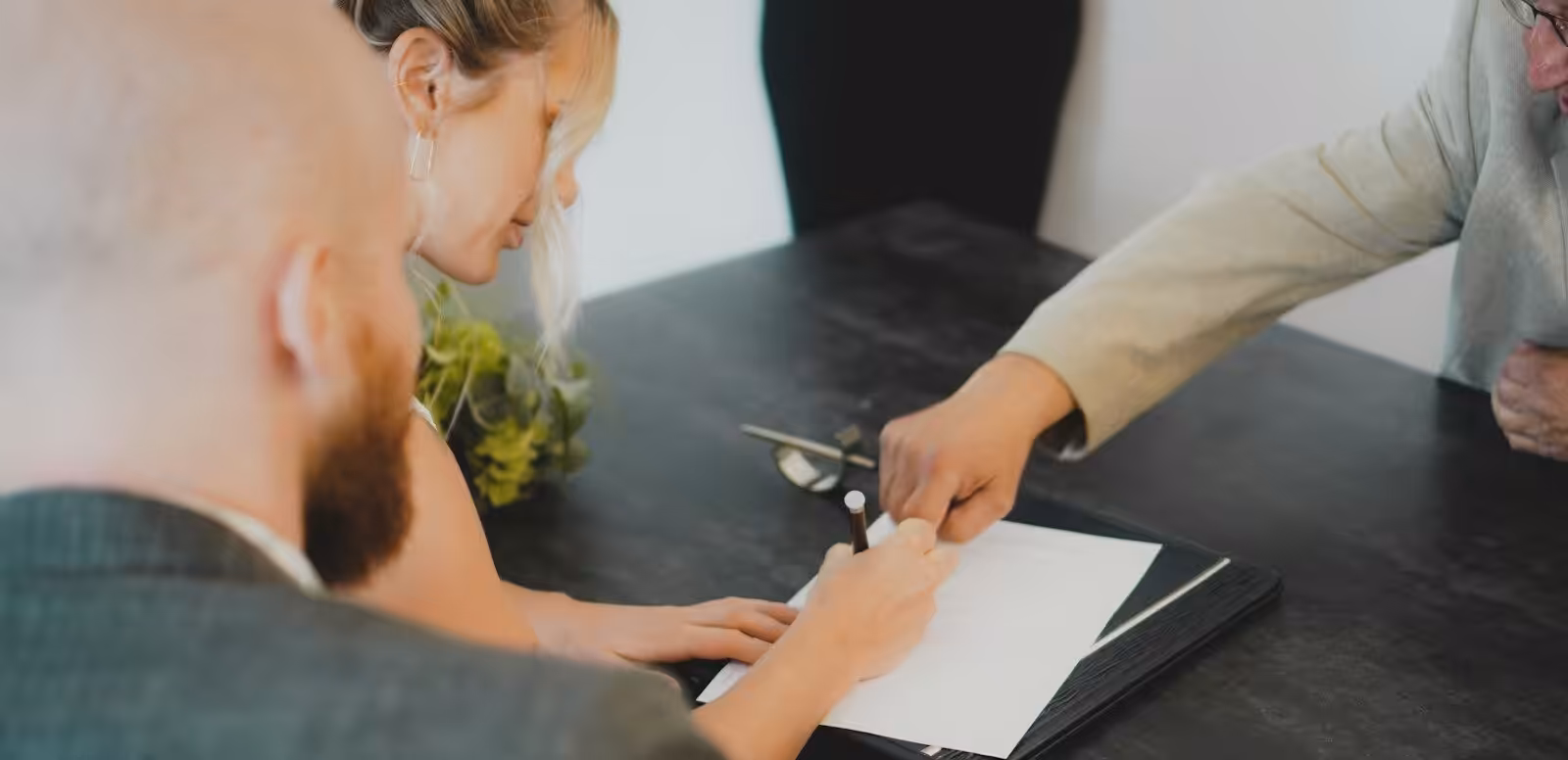 couple signing document at desk